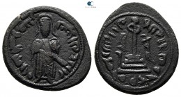 Umayyad Caliphate. Hims (Emesa) mint. Time of 'Abd al-Malik ibn Marwan AD 685-705. (AH 65-86). Standing caliph type. Struck circa 690s. Fals Æ