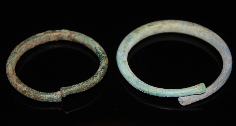 2nd millenium BC. A pair of bronze penannular arm bracelets. Intact, larger one ...