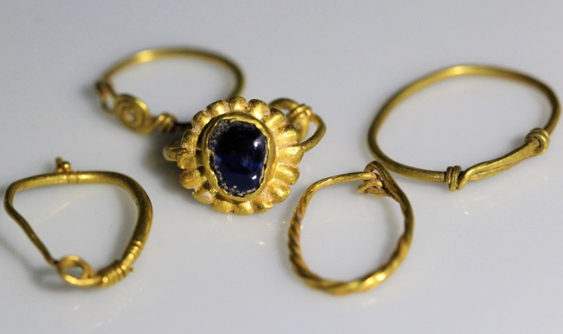 1st-4th century AD. Five pieces of gold earrings, including one with blue glass....
