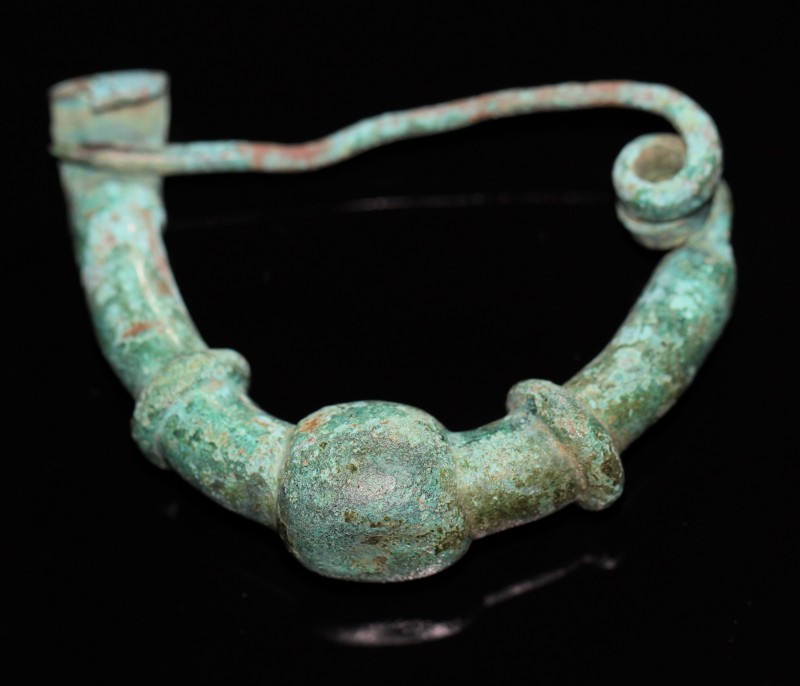 6th - 4th century BC. Bronze bow fibula with green patina, archaic Illyrian type...