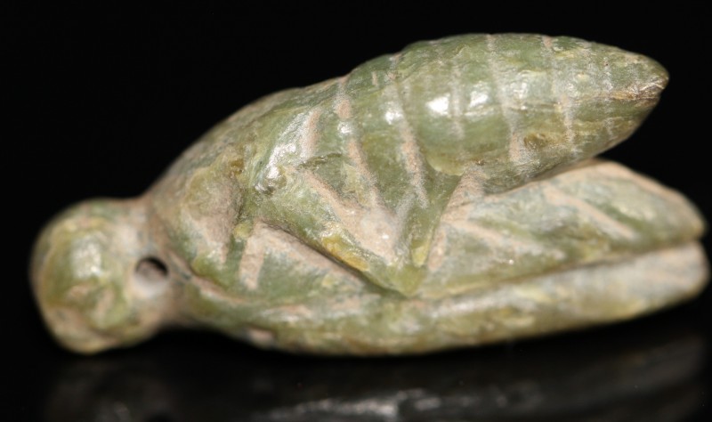 1st millenium BC. A carved semi-precious stone, possibly jade, of a locust. Inta...