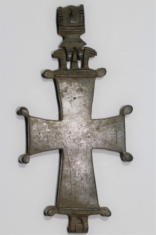 10th - 12th century. A bronze cross pendant featuring a hinged base and a suspen...
