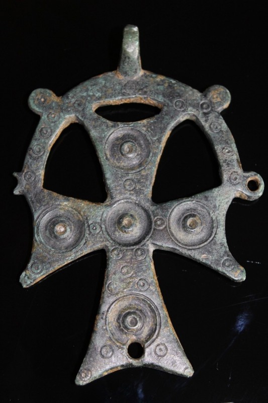 7th - 9th century AD. A large bronze cross decorated on one side with circle and...