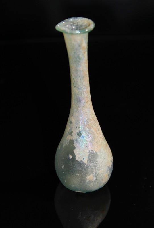 2nd century AD. A pale blue glass vial still displaying much of the original tra...