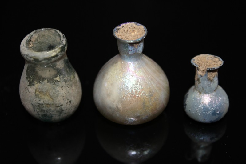1st - 3rd century AD. Group of three small glass vials, originally used for perf...