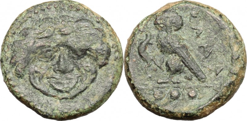 Sicily. Kamarina. AE, 425-405 BC. D/ Gorgoneion. R/ Owl standing left; holding l...