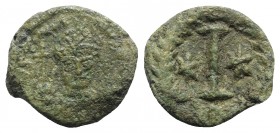 Justinian I (527-565). Æ 10 Nummi (19mm, 6.19g). Rome or Ravenna, 547-549. Helmeted and cuirassed facing bust, holding globus cruciger and shield. R/ ...