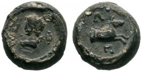 A Hellenistic or Roman lead seal or lead coin
Condition: About Very Fine, as in pictures.

Obverse: The bust of a young man to left, between the greek...