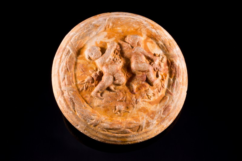 Roman Terracotta lid. c. 1st-3rd century AD (9.2cm). Circular lid depicting two ...