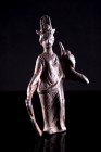 Roman Bronze Statuette of Isis. c. 1st-3rd century AD (8.8cm). A standing Isis wearing flowing robes and crowned with her typical headdress, holding a...