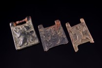 Lot of 3 Roman Bronze Belt-Fittings, depctings two animals, probably a wolf and a lion, and a horseman riding l. and holding a spear. c. 4 th century ...