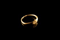 Roman Gold Finger Ring. c. 1st-2nd century AD (15mm). Oval section hoop, expanding in a wider surface engraved with a palm branch. Intact.