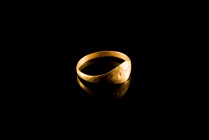 Roman Gold Finger Ring. c. 1st-2nd century AD (18mm). Oval section hoop, expanding in a wider surface engraved with a standing figure facing. Intact.