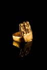 Roman Gold Finger Ring with rectangular projection, , c. 3rd-4th century AD (1.1x1.4 cm), depicting two lions seated outwards, with head reverted to b...