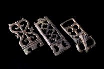 Lot of 3 Roman Bronze Fittings and Belt Buckles. c. 3th-4th century AD. All in openwork and with scrolled decoration. Intact.