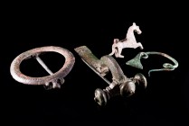Lot of 4 Roman Bronze Fibulae, c. 2nd-4th century AD, including horse-shaped (4.4cm), crossbow type (8.5cm), bow type (4.5cm) and disc-shaped (6.4cm).
