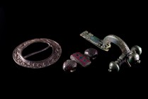 Lot of 3 Roman Bronze Fibulae. Different types, including a crossbow fibula, a disc fibula with floreal designs and one decorated with two snakes. 2nd...
