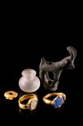 Lot of 5, comprising two gold finger rings, both with glass stone and one with band in shape of two dolphins, one little gold applique, one glass jar ...