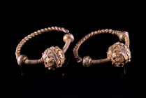 Pair of Byzantine Gilt Silver Earrings, c. 8th-10th century AD (5.7cm). Elaborately designed with twisted banded hoops and a larger spherical base. In...
