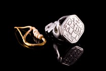 Lot of 2 Byzantine artefacts, including 1) a White Metal Stamp Seal, c. 13th-14th century (2,8cm, 6.55g) inscribed with +/NIKO/TZAN; 2) Gold Earring w...