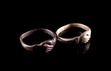 Lot of 2 Medieval Rings, one in silver and the other in bronze. c. 13th-15th century. Both marriage rings, showing clasped hands (dextrarum iunctio).