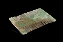 Medieval Bronze Comb, Anglo-Saxon or Viking, c. 7th-10th century (7.7cm), with incised decoration on one side. A flat-section one-piece comb. Green pa...