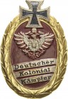 Medaillen und Abzeichen
 Vergoldetes, eilweise farbig bemaltes Blechabzeichen o.J. Deutscher Kolonial Kämpfer. 60,5 x 40,5 mm, 7,91 g. Mit Nadel Selt...