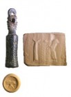 A BRONZE CYLINDER SEAL WITH A SCHEMATIC PAZUZU HEAD HANDLE Iron Age II, 7th-6th century BCE. 40.0 mm high, with the suspension loop. Depicting a worsh...