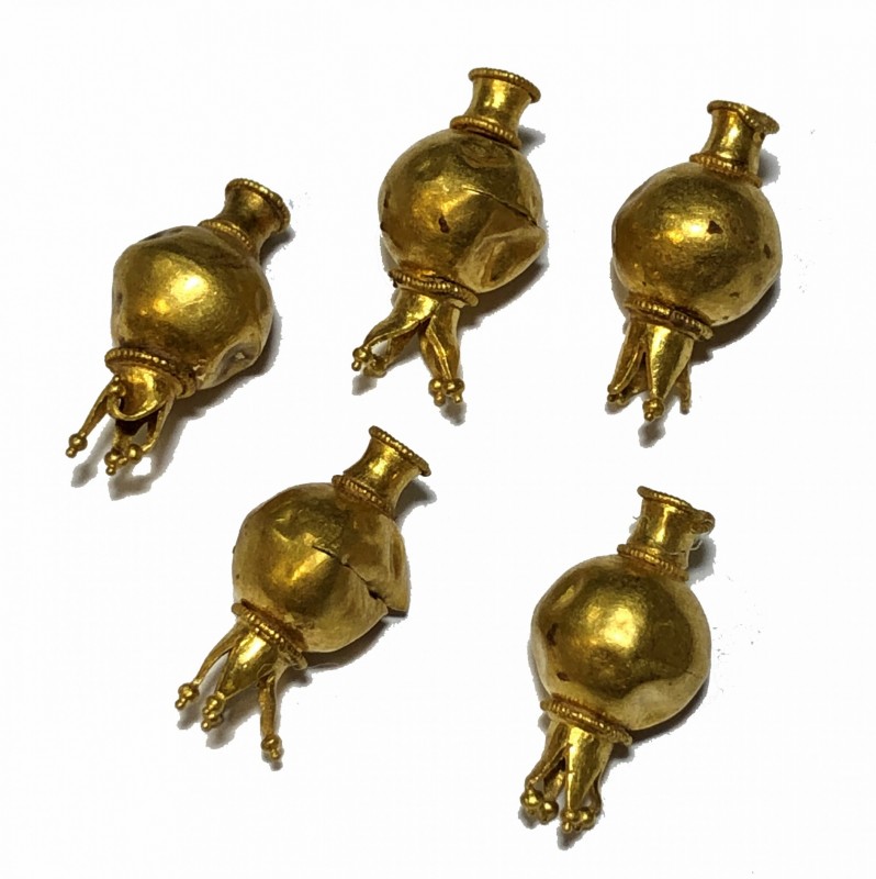 A LOT OF 5 GOLD BEADS IN THE FORM OF POMEGRANATES Hellenistic Period, 3rd-2nd ce...