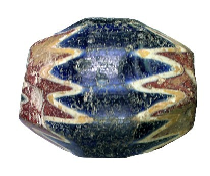 A LARGE BARREL-SHAPED BLUE WITH WHITE AND RED GLASS BEAD Ca. 15th century CE. 4....