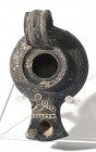 A BLACK TERRACOTTA OIL LAMP Herodian Period, 1st century CE. 10.1 cm. In very good condition. Ex Judge Steve Adler collection, Jerusalem (Adler catalo...