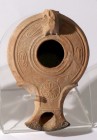 SOUTHERN TYPE TERRACOTTA OIL LAMP 1st-2nd century CE. 11.7 cm. Decorated with a swirl rosette and two kernels of wheat. In very good condition and rar...