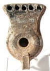 A BEIT NATIF TYPE TERRACOTTA OIL LAMP WITH 5 NOZZLES 4th century CE. 13.6 cm. With doted decorated . In very good condition. Ex Shlomo Moussaieff coll...