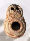 A BEIT-NATIF TYPE CLAY OIL LAMP With 2 nozzles. 4th century CE. 8.2 cm. With a geometric decoration. In fair condition. Ex Judge Steve Adler collectio...