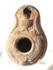 A BEIT-NATIF TYPE CLAY OIL LAMP 4th century CE. 8.2 cm. Decorated with an amphora and grapes. In good condition. Ex Judge Steve Adler collection, Jeru...