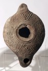 A LARGE TERRACOTTA OIL LAMP 6th-8th century CE. 15.6 cm. Decorated with linear motifs. In very good condition. Ex Shlomo Moussaieff collection, Herzli...