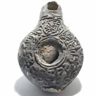 A SAMARITAN TERRACOTTA OIL LAMP 5th-6th century CE. 8.3 cm. Decorated on the nozzle with a circle containing wavy lines and with a Samaritan inscripti...