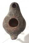 A SAMARITAN TERRACOTTA OIL LAMP 5th-6th century CE. 9.0 cm. Decorated on the nozzle with two arches and a palm branch stemming from a wheel design on ...