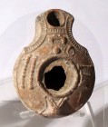 A TERRACOTTA OIL LAMP Samaritan, 4th century CE. 8.5 cm. Decorated with musical instruments. In very good condition. Ex Shlomo Moussaieff collection, ...