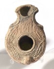 A TERRACOTTA OIL LAMP Samaritan, 4th century CE. 8.5 cm. Decorated with a sanctuary. In very good condition. Ex Shlomo Moussaieff collection, Herzliya...