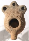 A SAMARITAN TERRACOTTA OIL LAMP 4th century CE. 12.8 cm. With 3 restored nozzles. Decorated with geometric motifs. Ex Judge Steve Adler collection, Je...