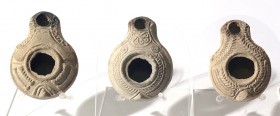 A LOT OF 3 TERRACOTTA OIL LAMPS Samaritan Period, 4th century CE. 8.4, 8.2 and 8.0 cm. In very good condition. Ex Aka Mizrahi collection, Tiberias.