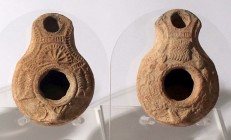 2 SAMARITAN TERRACOTTA OIL LAMPS 4th century CE. One decorated with a basket and pomegranates, and the second with a temple. In good condition. Ex Shl...