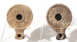 A LOT OF 2 TERRACOTTA OIL LAMPS FROM PALMYRA (TADMOR) 1st century CE. Inscribed: עגלבול ומלכבל. 8.0 and 8.3 cm. In fair condition. See: Qedem 8, p. 51...