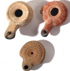 A LOT OF 3 TERRACOTTA OIL LAMPS Hellenistic Period, 3rd-1st century BCE. 9.4, 9.3, 7.2 cm. In good condition. Ex Judge Steve Adler collection, Jerusal...