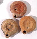 A LOT OF 3 TERRACOTTA OIL LAMPS Roman Period, 2nd-4th century CE. 8.6 cm each. One depicting the head of Medusa and 2 the bust of Pan. In good conditi...