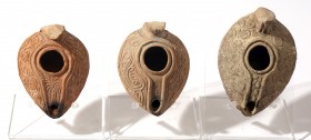 A LOT OF 3 TERRACOTTA OIL LAMP Early Islamic Period, 7th-8th century CE. Decorated with geometric and floral motifs. In very good condition. Ex Miriam...
