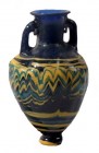 A SAND-CORE GLASS AMPHORISKOS 6th-5th century BCE. 7.1 cm high. With very nice cobalt blue, yellow and turquoise colors. Mended at the neck but in ver...