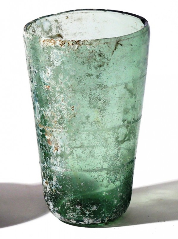 A TRANSLUCENT GLASS BEAKER Roman Period, 1st-2nd century CE. 11.2 cm high. With ...