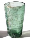 A TRANSLUCENT GLASS BEAKER Roman Period, 1st-2nd century CE. 11.2 cm high. With incised circular decorations. In very good condition (with a minor chi...